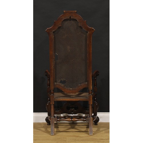 425 - A William & Mary Revival walnut armchair, shaped cresting, scroll hand rests, shaped front stretcher... 