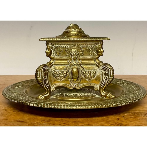 A 19th century Continental brass inkstand, triangular inkwell cast with ...
