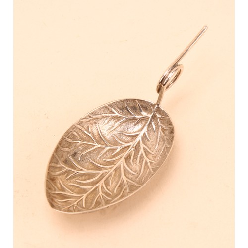 A George III silver leaf shaped caddy spoon, loop handle, apparently ...