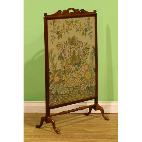 An early 20th century mahogany and beech fire screen, woolwork banner ...