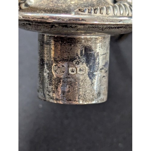 5042 - A silver two branch candlestick, detachable sconces, central cover with flame finial, 36cm, Walker &... 