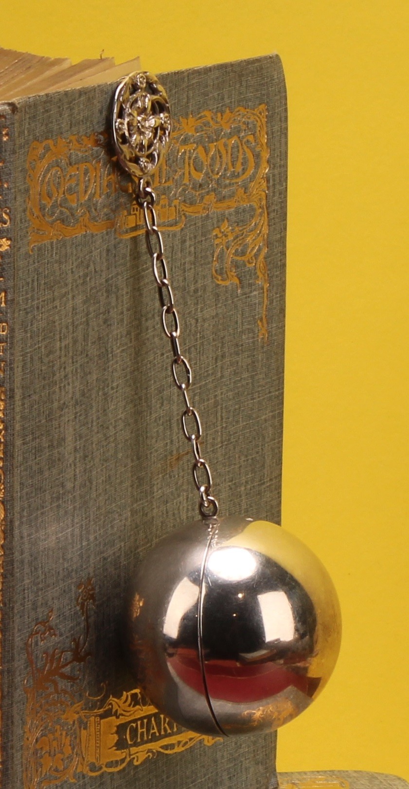 An Edwardian silver spherical pomander of plain design, the suspension ...