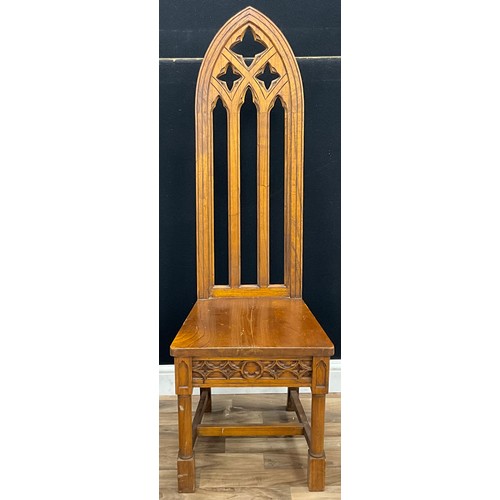 100 - A Gothic style carved solid oak side chair, 138cm high, 45cm wide, 40cm seat depth