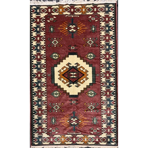 117 - A Turkish Loki rug, with vibrant geometric panelled field, in tones of red, russet, orange, cream, t... 