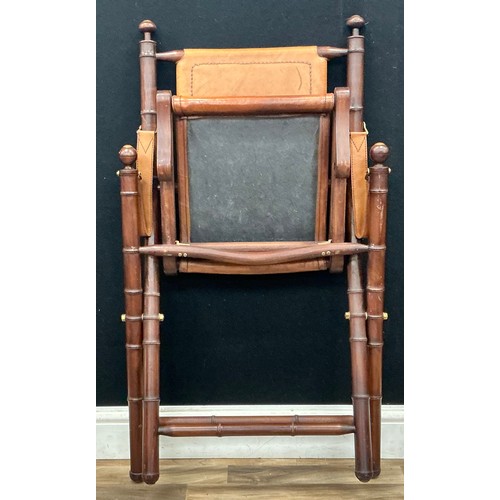 214 - A contemporary campaign chair, bamboo effect stretchers and brass mounts, leather canvas, 87cm high.