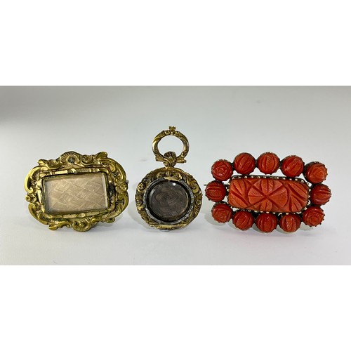 317 - A selection of mourning jewellery,
to include a carved coral woven hair panel mourning brooch, appro... 