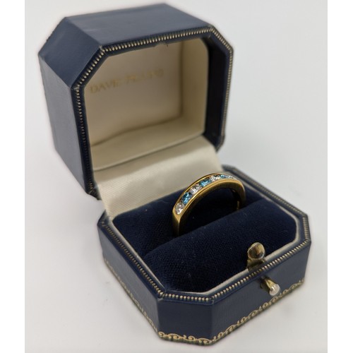 324 - An 18ct gold blue and white synthetic diamond seven stone ring, 
set with three approx. 0.05ct round... 