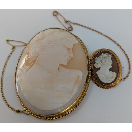 327 - Two 9ct gold mounted oval shell cameo brooches,
to include a large 