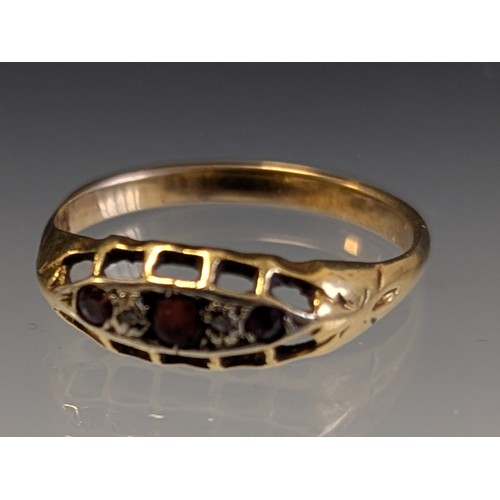 331 - An 18ct gold pyrope-almandine garnet and illusion set diamond five stone ring, 
hallmarked 