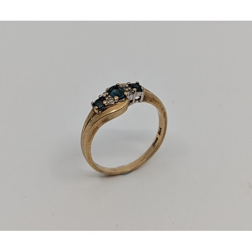 340 - A 9ct gold greenish blue paste stone and diamond dress ring, 
set with a central approx. 5mm x 3mm o... 