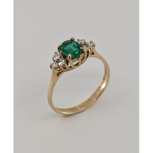 341 - A 9ct gold emerald and diamond dress ring, 
set with a central approx. 0.40ct oval brilliant cut lig... 