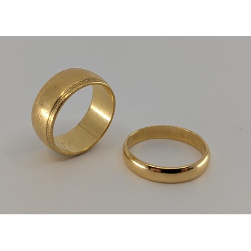 344 - Two 18ct gold wedding bands, 
one of them is approx. 7mm wide, stamped 