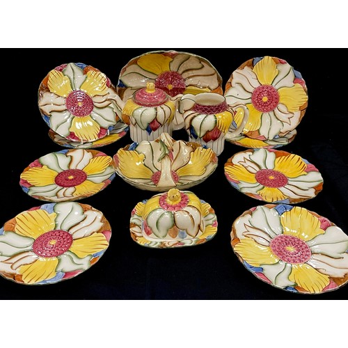 67 - Burslem ware including a flower shaped tea pot, basket, jug, butter dish, serving dish, eight plates... 