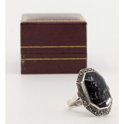 320 - A Blue John and marcasite set silver ring, 
set with a rectangular step cut shaped blue john piece m... 