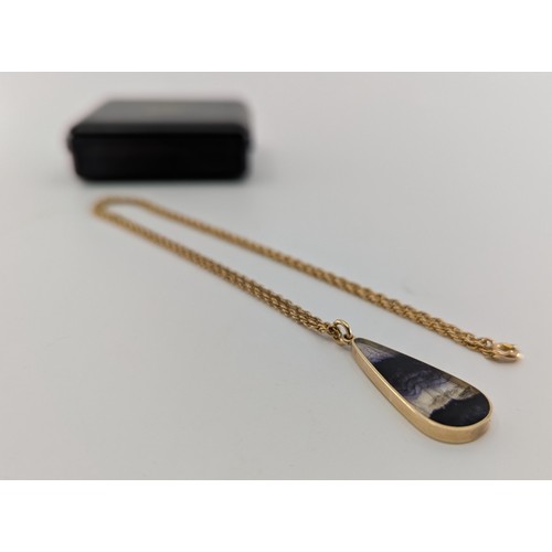 326 - A 9ct gold mounted blue john pendant necklace, 
the 9ct gold mounted pear cut flat cabochon blue joh... 