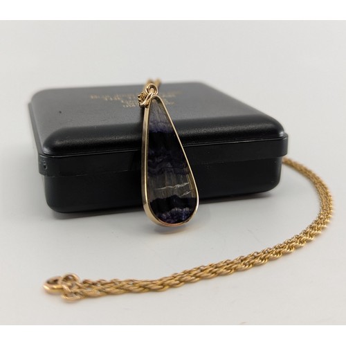 326 - A 9ct gold mounted blue john pendant necklace, 
the 9ct gold mounted pear cut flat cabochon blue joh... 