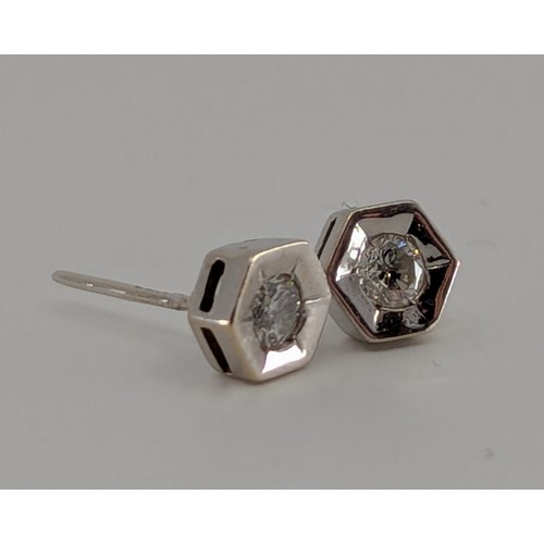 300 - A pair of diamond stud earrings, round brilliant cut diamonds each 0.12ct, mounted within 18ct white... 