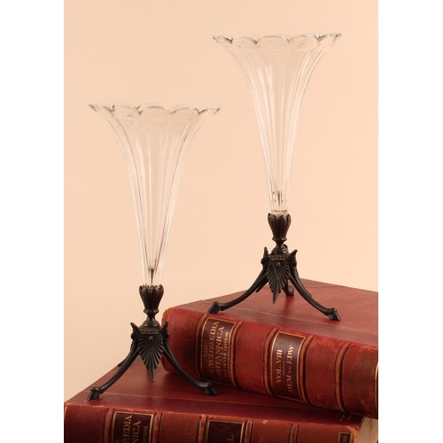 A pair of bronze and facet cut glass trumpet shaped mantle vases, petal ...