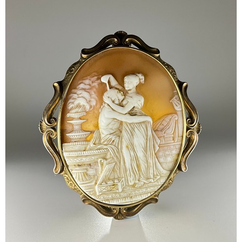 168 - A Victorian tested 9ct gold mounted oval shell cameo brooch, the cameo carved with a couple embracin... 