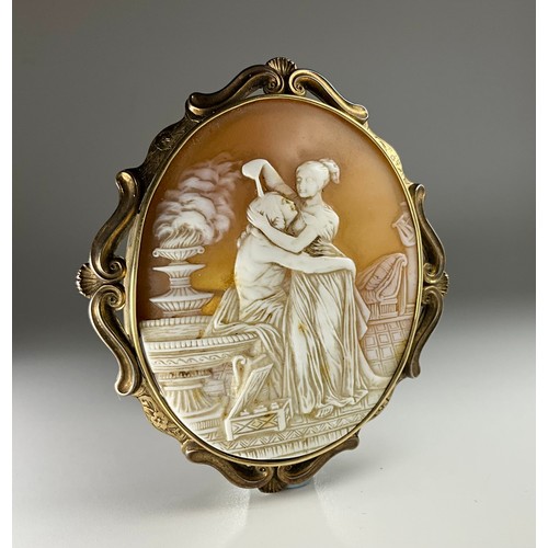 168 - A Victorian tested 9ct gold mounted oval shell cameo brooch, the cameo carved with a couple embracin... 