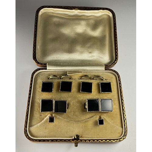 133 - A pair of 9ct gold black onyx set cufflinks, shirt studs, and collar studs, set with square shaped p... 