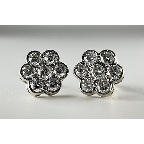 131 - A pair of 18ct white gold diamond cluster earrings, 
each earring set with a central approx. 0.15ct ... 