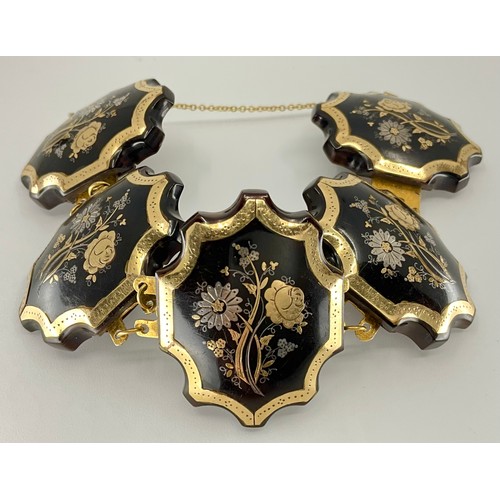 163 - A Victorian pique work tortoiseshell bracelet, comprised of five panels each with an inlaid flower d... 