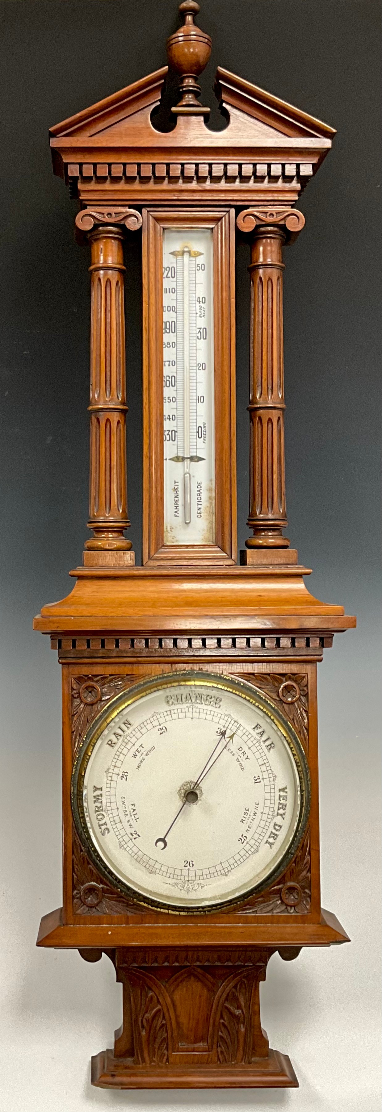 A Victorian Aneroid Barometer, the carved mahogany architectural case ...