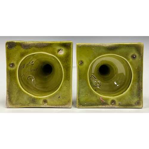 214 - A pair of Burmantoft's Faience Corinthian column candlesticks, pale green glaze, impressed marks to ... 