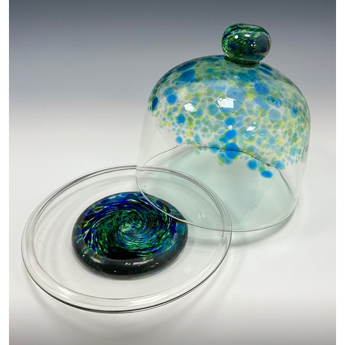 219 - A Cowdy Studio Glass Cheese Dome, Green, blue, and yellow twisted globular handle, to the mottled bl... 