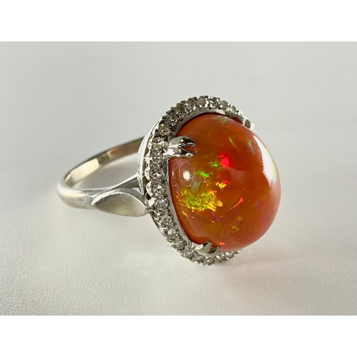 145 - A cabochon fire opal and diamond ring - the tested 18ct white gold ring, set with an approx. 7.10ct ... 