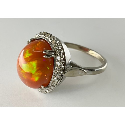145 - A cabochon fire opal and diamond ring - the tested 18ct white gold ring, set with an approx. 7.10ct ... 