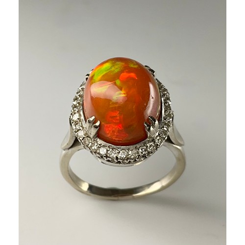 145 - A cabochon fire opal and diamond ring - the tested 18ct white gold ring, set with an approx. 7.10ct ... 