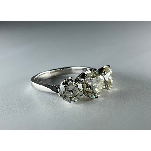 189 - An 18ct white gold diamond three stone ring, set with a central 1.40ct round brilliant cut diamond, ... 