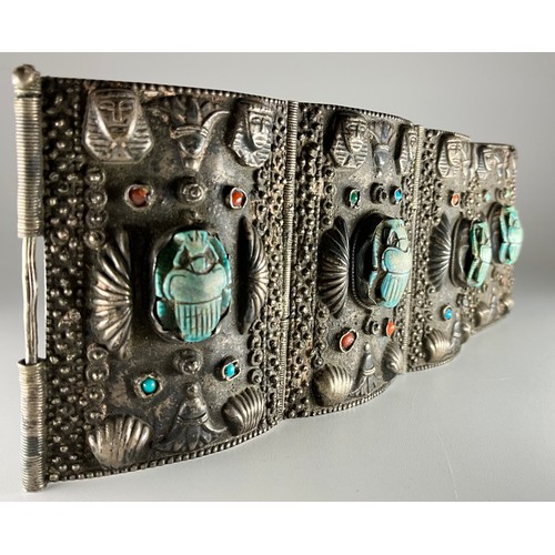 152 - A tested silver Egyptian Revival scarab cuff bracelet, 
possibly 900 grade silver, made up of four r... 
