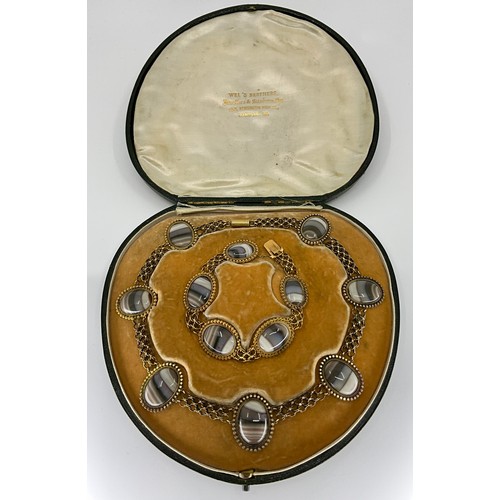 162 - A Victorian pinchbeck banded agate necklace and bracelet suite, 
the necklace set with seven oval ca... 