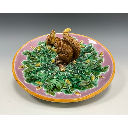 237 - A George Jones majolica Squirrel nut dish, moulded with a squirrel holding an acorn, the circular di... 