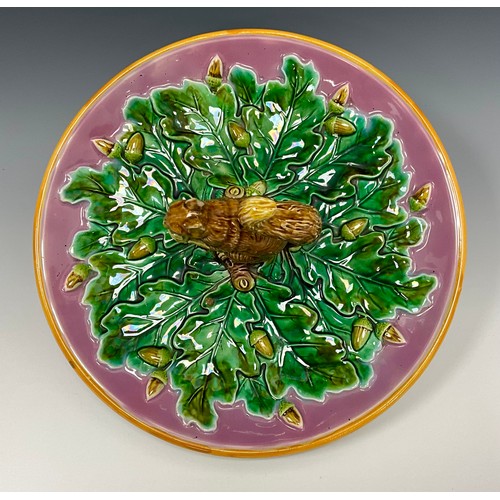 237 - A George Jones majolica Squirrel nut dish, moulded with a squirrel holding an acorn, the circular di... 