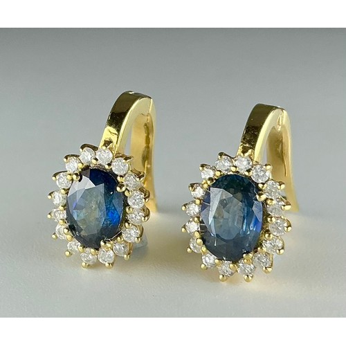 130 - A pair of 18ct gold sapphire and diamond cluster earrings, each earring set with an approx. 0.80ct m... 