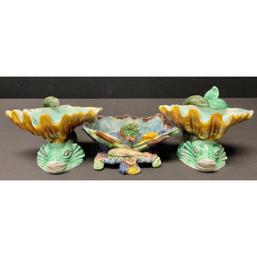 145 - A pair of Victorian Wedgwood Majolica porcelain salt stands, as shell mounted dolphins, 10cm high; a... 