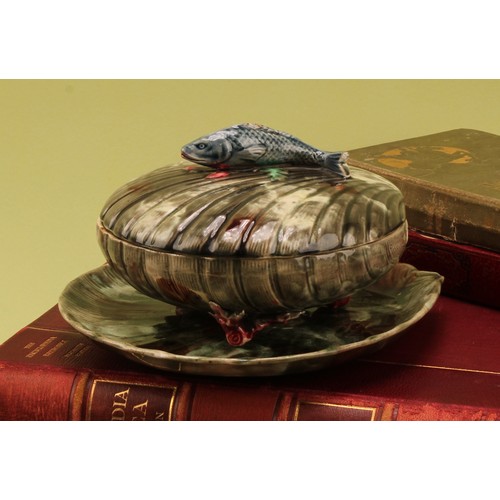147 - A 19th century Majolica covered sardine dish and stand, scallop shell form with fish handle, coral f... 