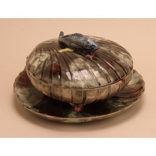 147 - A 19th century Majolica covered sardine dish and stand, scallop shell form with fish handle, coral f... 