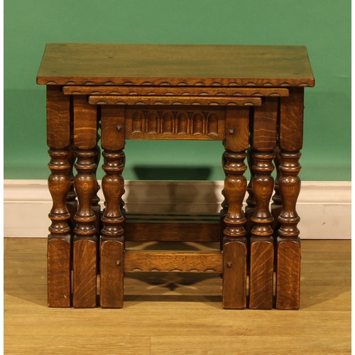 9 - An oak nest of three occasional tables, by Nigel Griffiths Monastic Woodcraft, the largest signed an... 