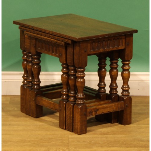 9 - An oak nest of three occasional tables, by Nigel Griffiths Monastic Woodcraft, the largest signed an... 