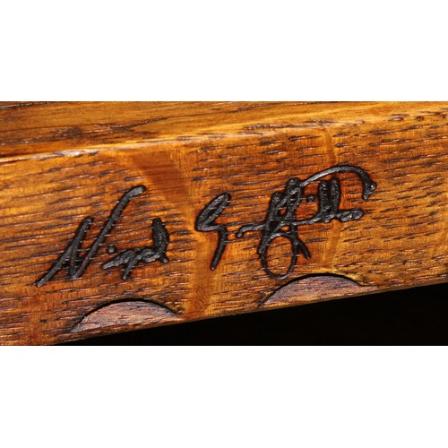 9 - An oak nest of three occasional tables, by Nigel Griffiths Monastic Woodcraft, the largest signed an... 