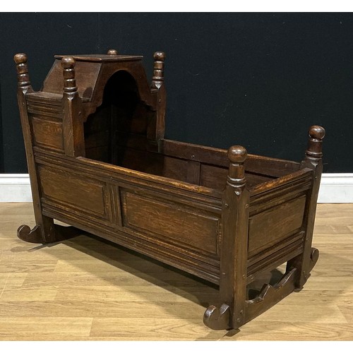 3 - An oak rocking crib, by Nigel Griffiths Monastic Woodcraft, signed, 88cm long