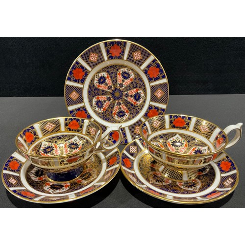 56 - A pair of Royal Crown Derby Imari 1128 pattern tea cups and saucers, first quality; a single 1128 pa... 