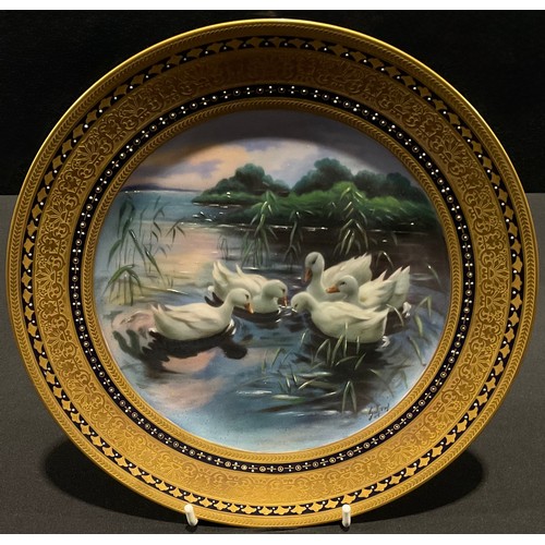 70 - A Vienna cabinet plate, painted with white ducks dabbling, 23.5cm, printed blue beehive mark and Heu... 