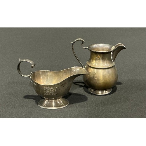 81 - An Edwardian silver cream jug, Nathan & Hayes, Chester 1901; another marks worn possibly Birmingham ... 