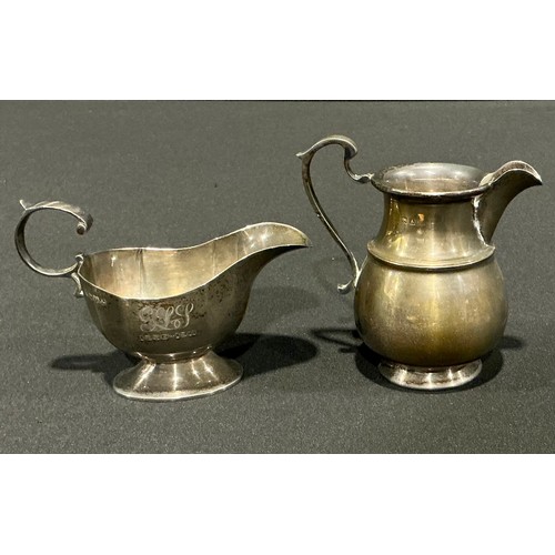 81 - An Edwardian silver cream jug, Nathan & Hayes, Chester 1901; another marks worn possibly Birmingham ... 